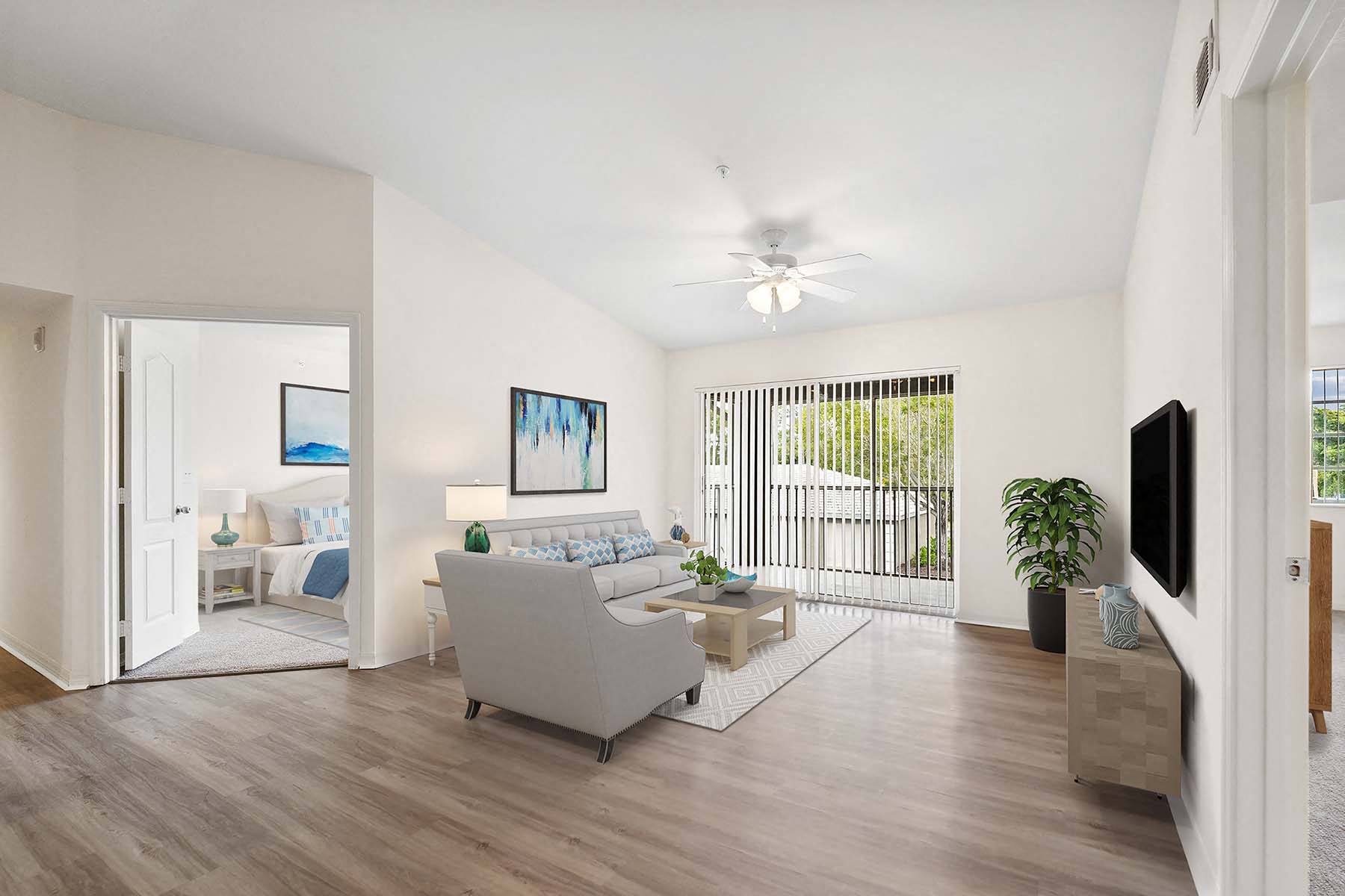 a living room with a couch and a ceiling fan